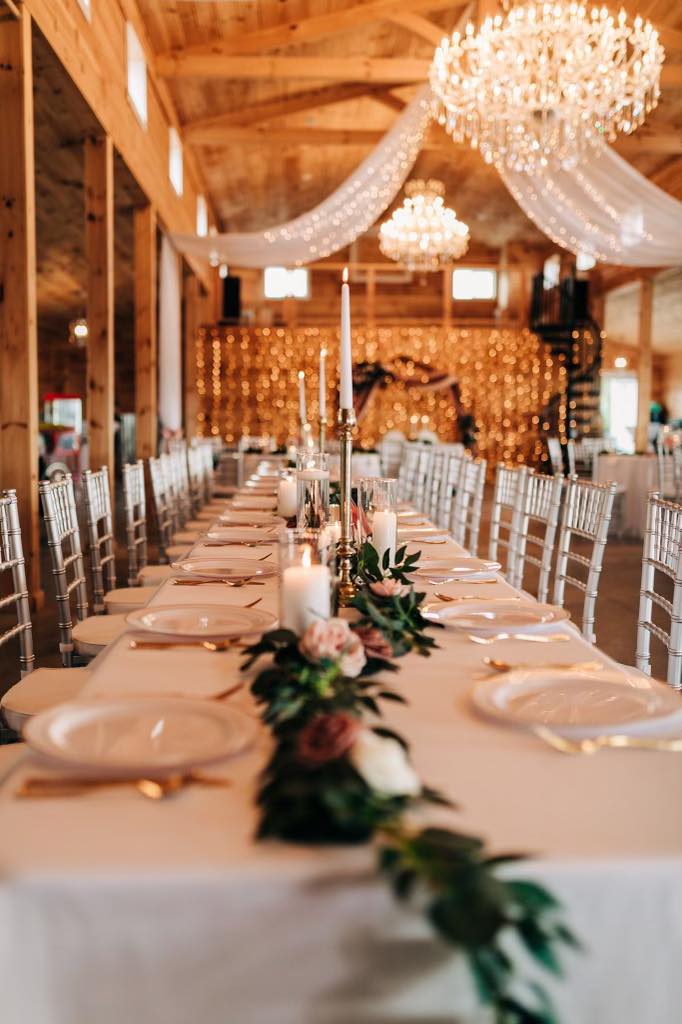 long wedding reception table with floral table runner