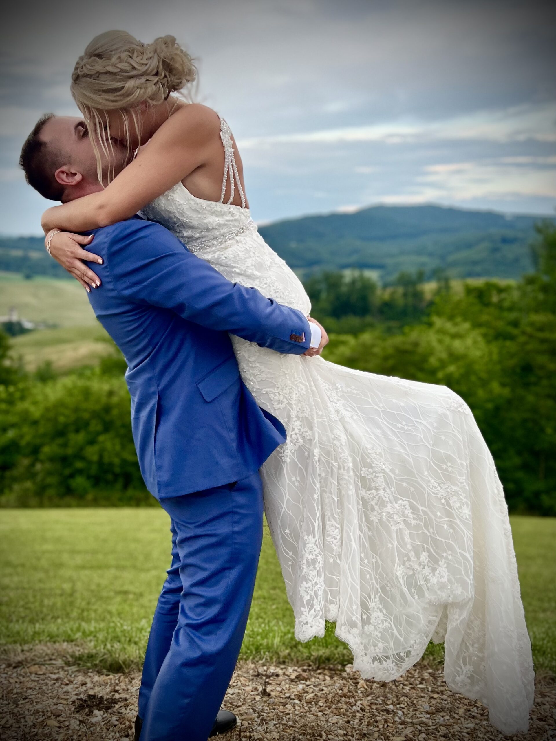 Bride and groom kissing outdoors