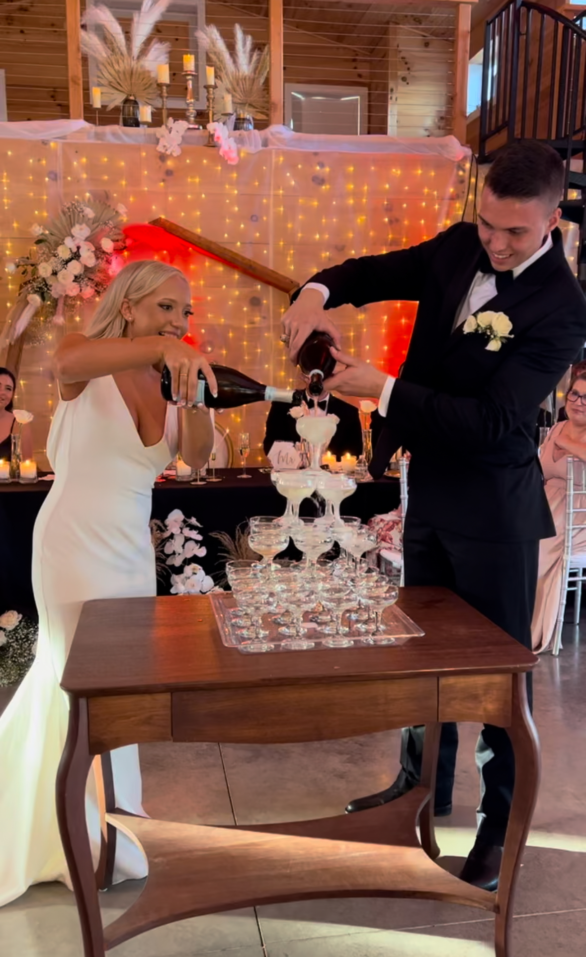 bride and groom pouring champagne