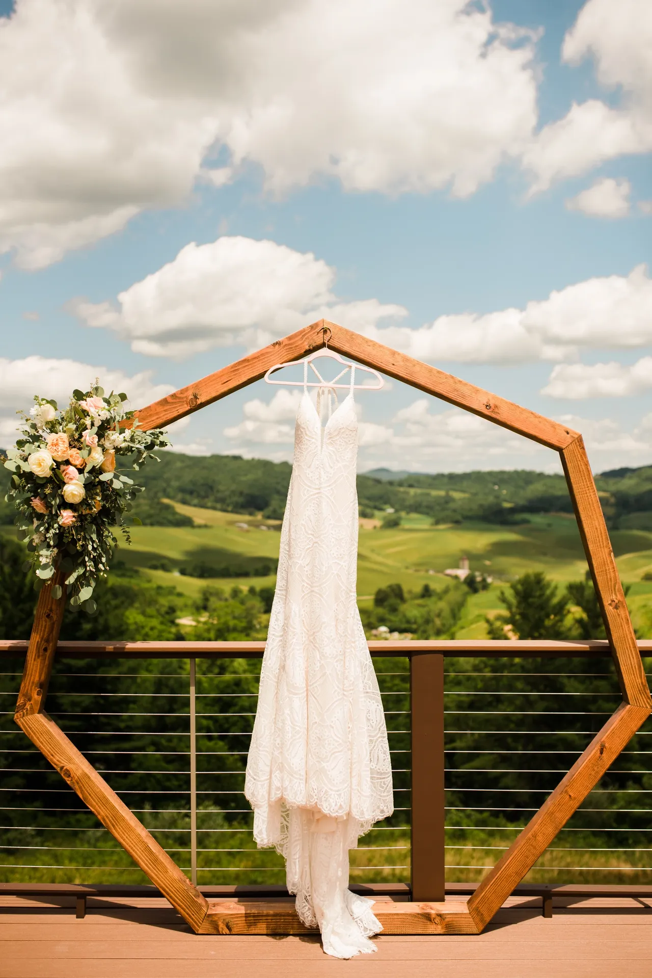 wedding gown hanging on archway with mountains in background
