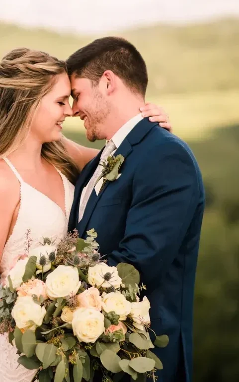 bride and groom embracing with mountains in the distance